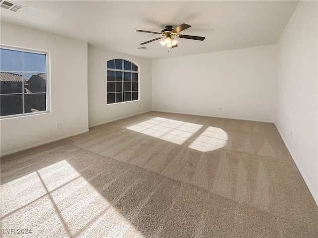 spare room with ceiling fan and carpet floors