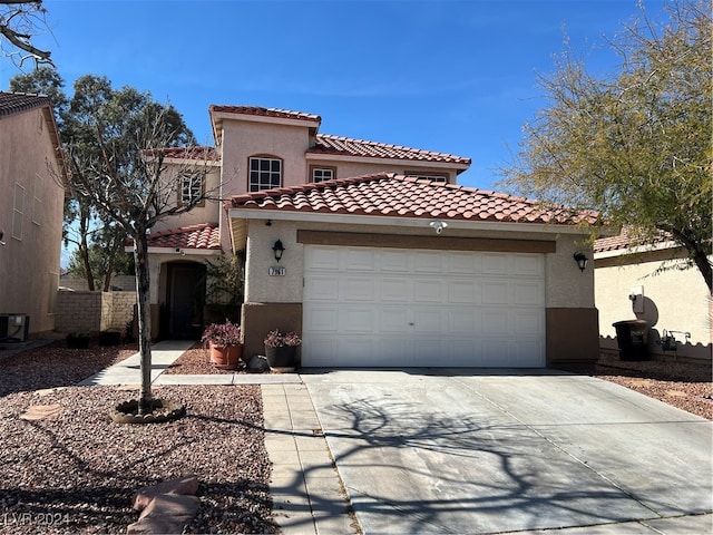 mediterranean / spanish-style home featuring central AC and a garage