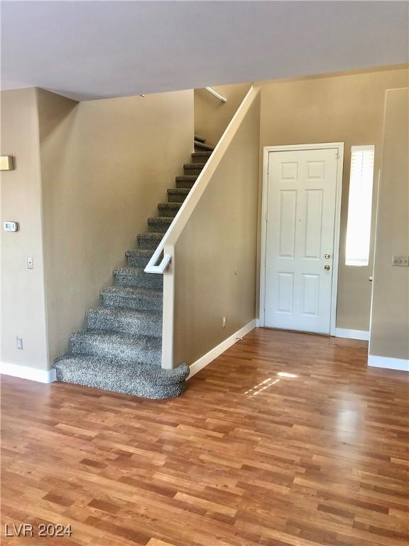 stairway with hardwood / wood-style floors