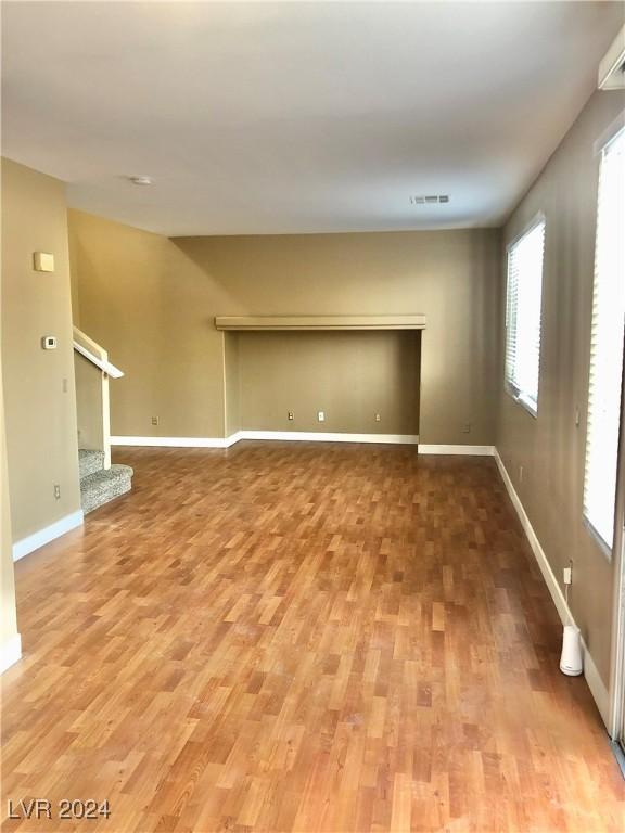 unfurnished living room featuring wood-type flooring