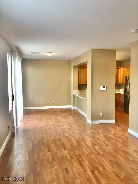 unfurnished living room with hardwood / wood-style flooring