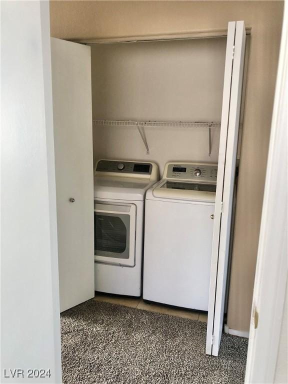 laundry room featuring dark colored carpet and washing machine and dryer