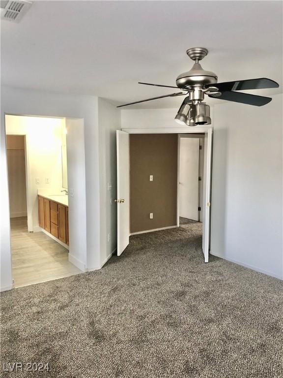 spare room featuring carpet floors and ceiling fan