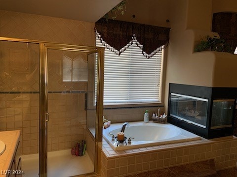 bathroom with tile patterned flooring, vanity, and separate shower and tub