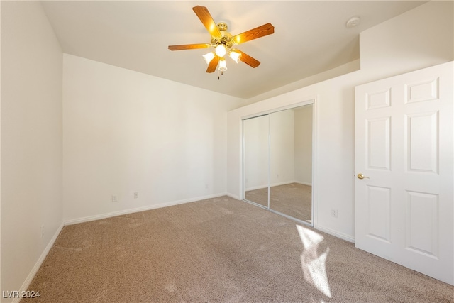 unfurnished bedroom with carpet floors, a closet, and ceiling fan