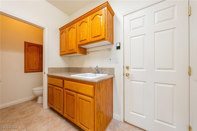 kitchen featuring light tile patterned floors and sink