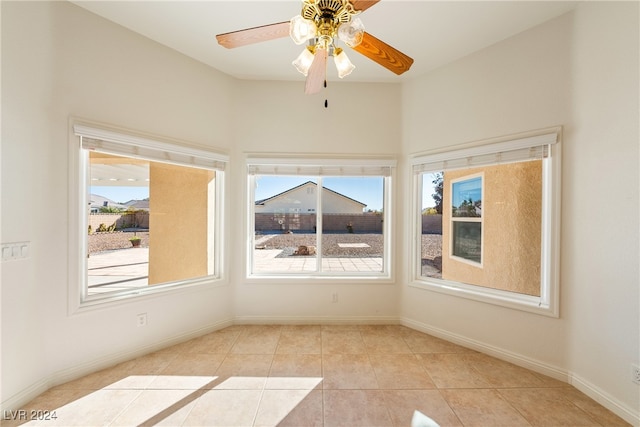 unfurnished room featuring ceiling fan and light tile patterned floors