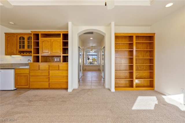 kitchen with dishwasher, ceiling fan, sink, and light carpet