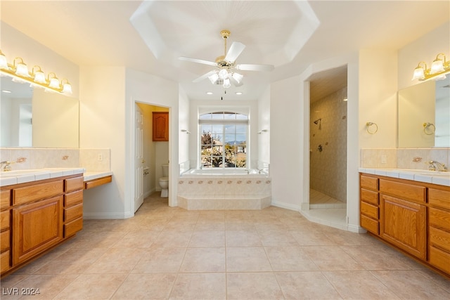 full bathroom with tile patterned floors, ceiling fan, separate shower and tub, and toilet