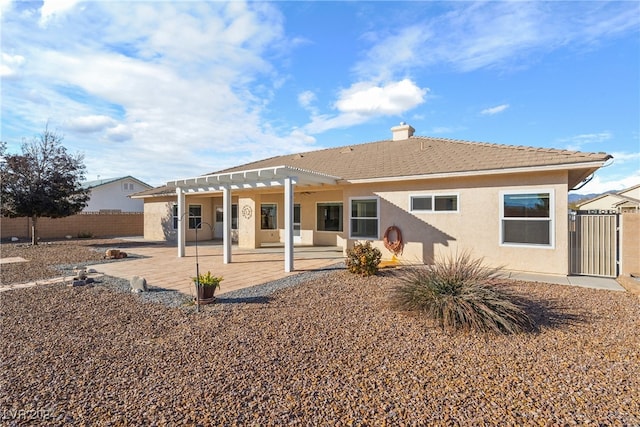 rear view of house with a pergola and a patio