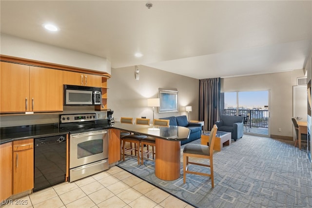 kitchen featuring open shelves, stainless steel appliances, dark countertops, open floor plan, and a peninsula