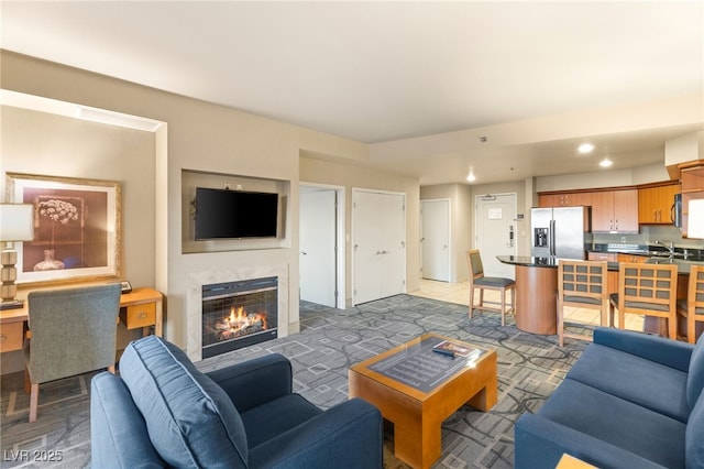 living room with recessed lighting and a premium fireplace