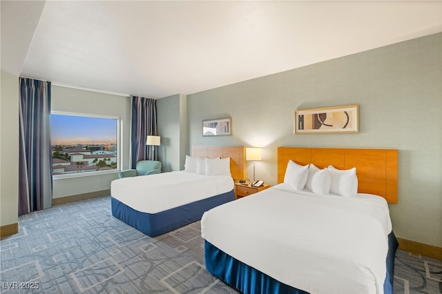 bedroom featuring carpet and baseboards