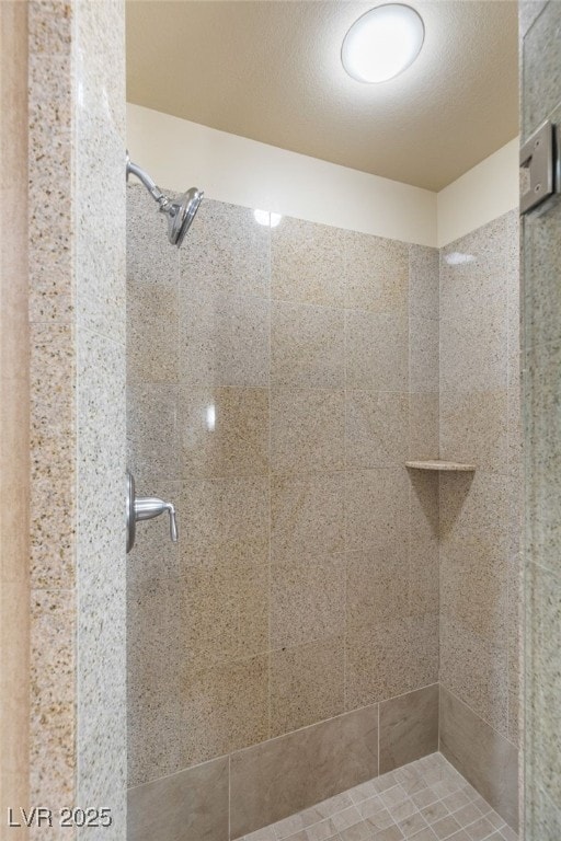 full bathroom with a stall shower and a textured ceiling