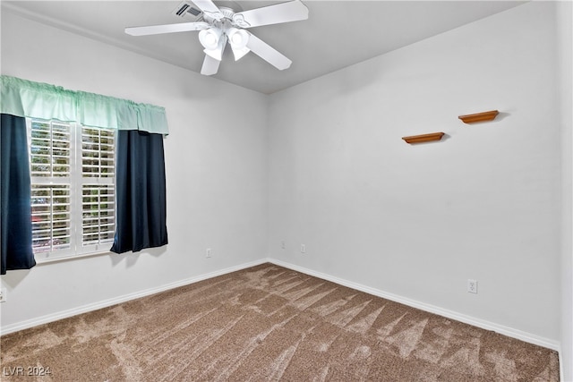 carpeted empty room featuring ceiling fan