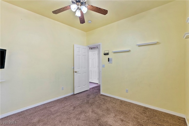 empty room featuring ceiling fan and carpet floors