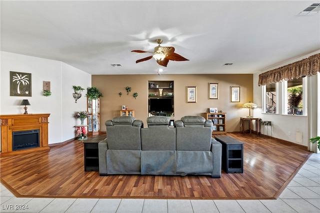 living room featuring ceiling fan and light hardwood / wood-style floors