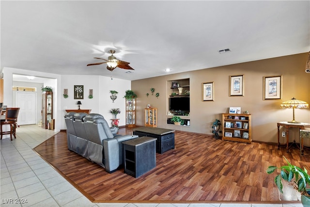 living room with hardwood / wood-style flooring and ceiling fan