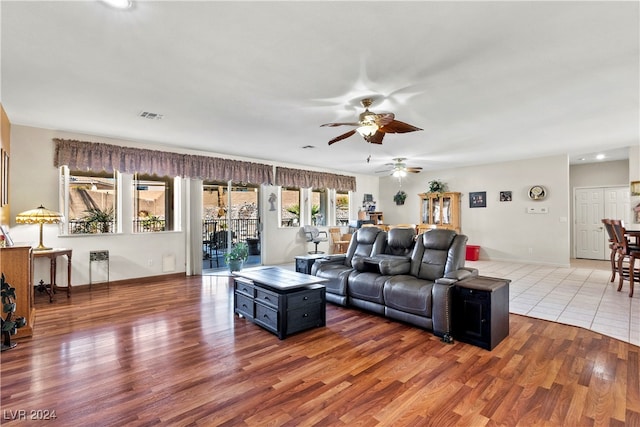 living room with ceiling fan and wood-type flooring