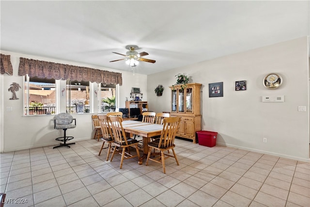 dining space with ceiling fan and light tile patterned floors