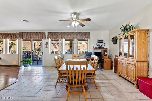 dining space with ceiling fan, plenty of natural light, and light tile patterned floors