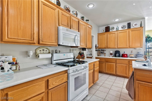 kitchen with light tile patterned floors and white appliances