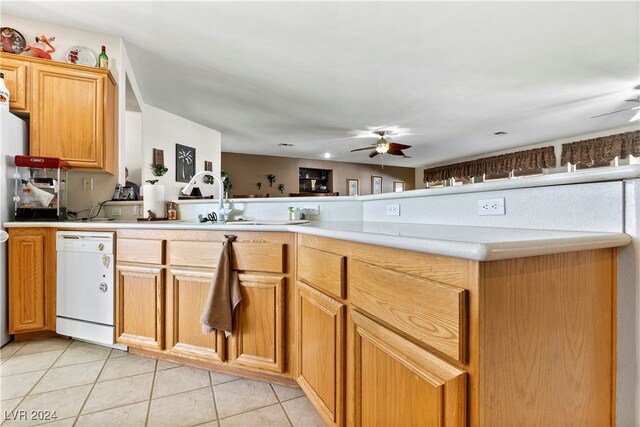 kitchen featuring ceiling fan, dishwasher, sink, kitchen peninsula, and light tile patterned flooring