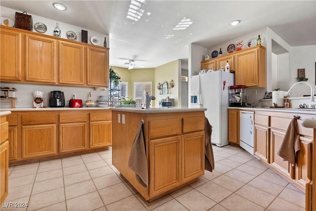 2349 Cottage View Ct, Laughlin, NV 89029 - kitchen with white appliances, a sink, light countertops, light tile patterned flooring, and recessed lighting