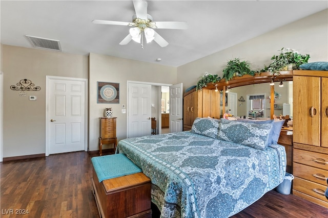 bedroom with dark hardwood / wood-style flooring and ceiling fan