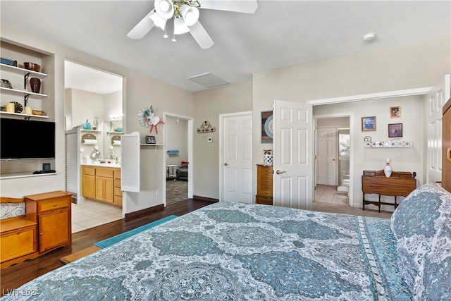 bedroom featuring ceiling fan, ensuite bathroom, and light hardwood / wood-style flooring