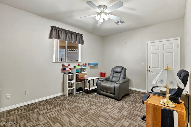 sitting room featuring carpet and ceiling fan