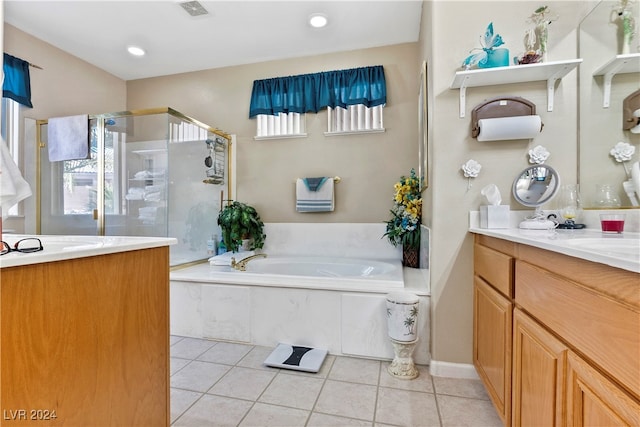 bathroom with tile patterned flooring, vanity, and plus walk in shower