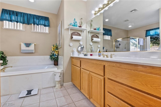 bathroom with tile patterned floors, vanity, and shower with separate bathtub