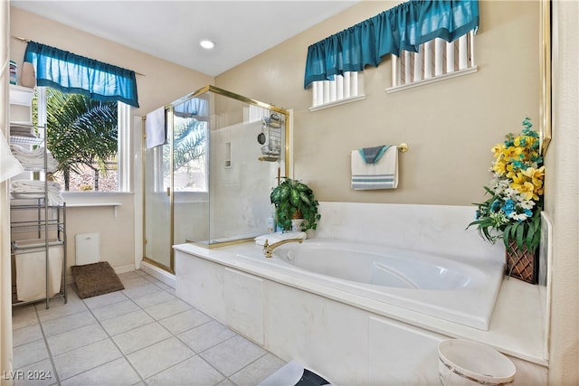 bathroom featuring tile patterned flooring and shower with separate bathtub