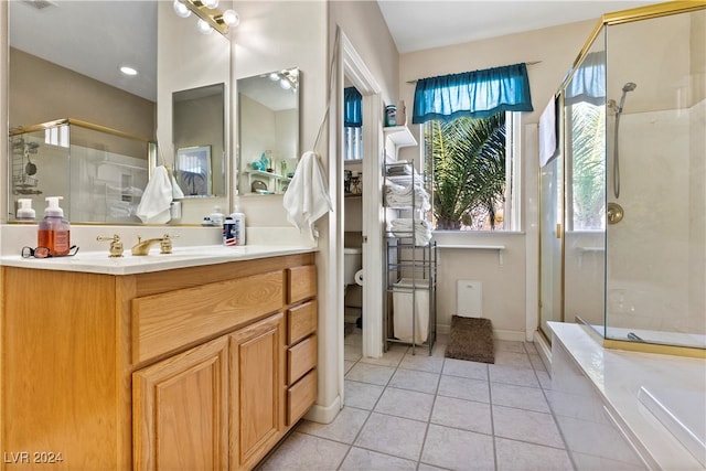 bathroom with tile patterned flooring, vanity, toilet, and a shower with door