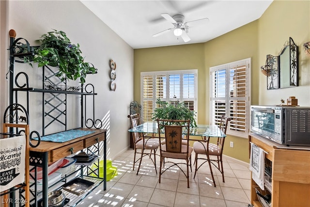 dining area with ceiling fan and light tile patterned floors