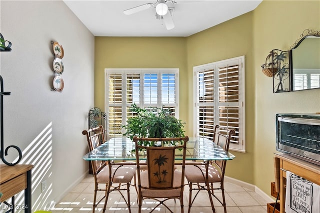 dining space featuring ceiling fan and light tile patterned floors