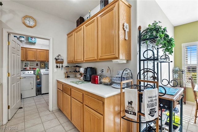 kitchen with washer and clothes dryer and light tile patterned floors