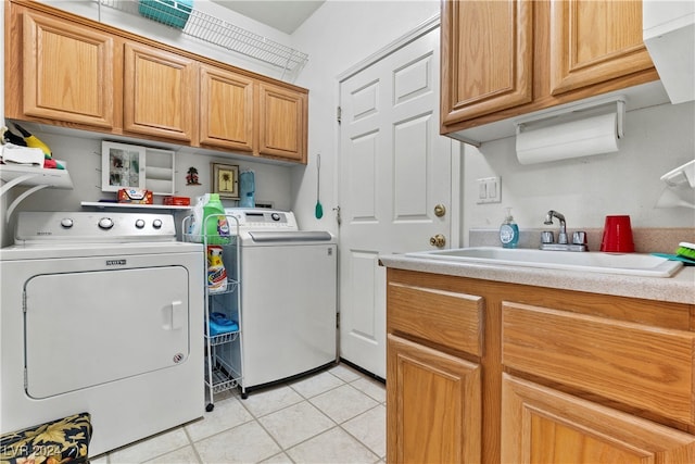 washroom with cabinets, sink, washer and clothes dryer, and light tile patterned flooring