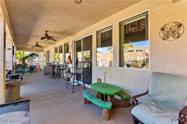 view of patio featuring ceiling fan