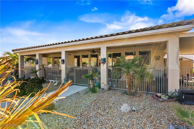 exterior space featuring ceiling fan