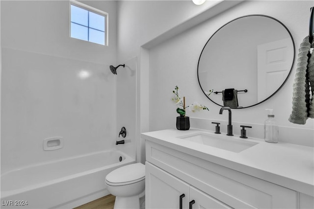 full bathroom with hardwood / wood-style flooring, toilet, vanity, and tub / shower combination