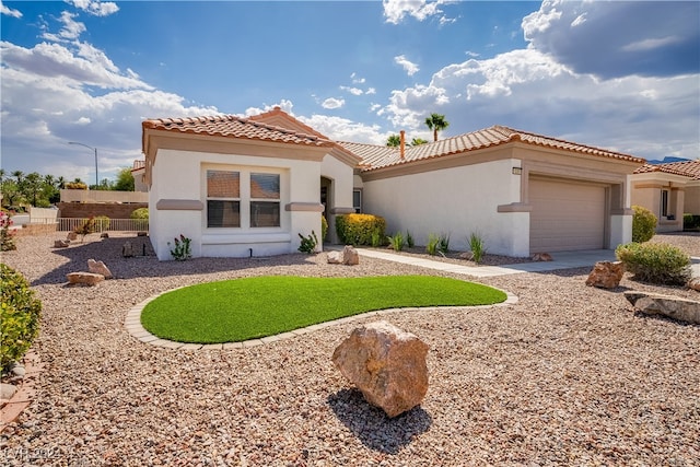 mediterranean / spanish-style home featuring a garage