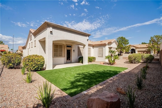 rear view of house featuring a lawn