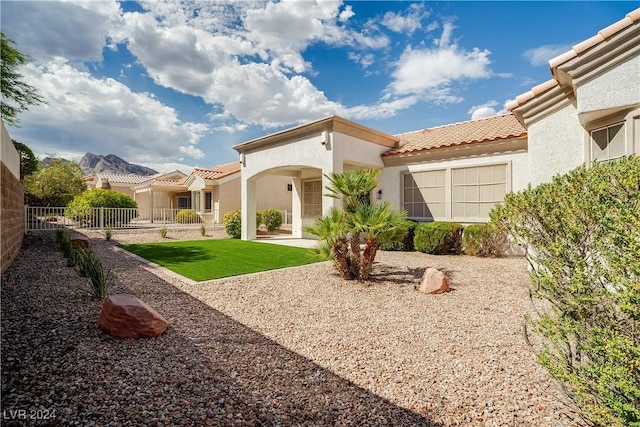 rear view of property with a yard