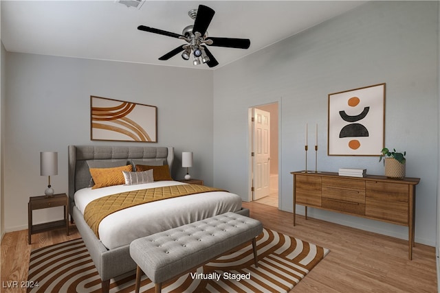 bedroom featuring connected bathroom, light hardwood / wood-style flooring, and ceiling fan