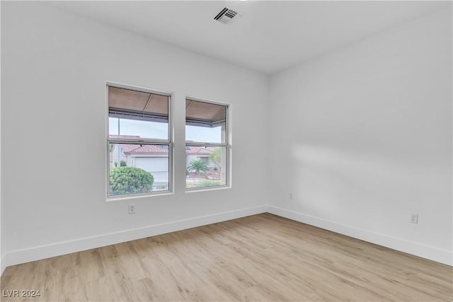 unfurnished room featuring light hardwood / wood-style floors