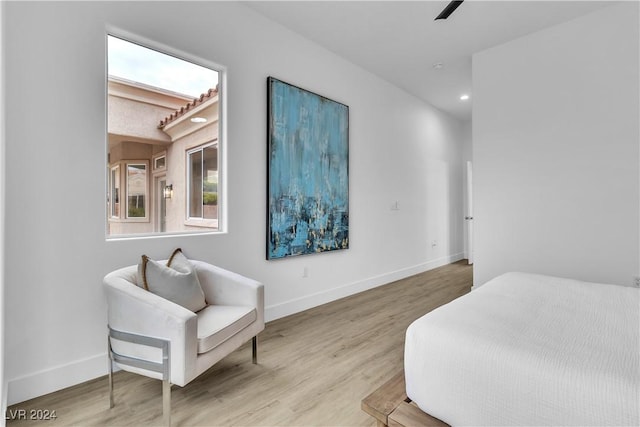 bedroom with ceiling fan and light hardwood / wood-style flooring