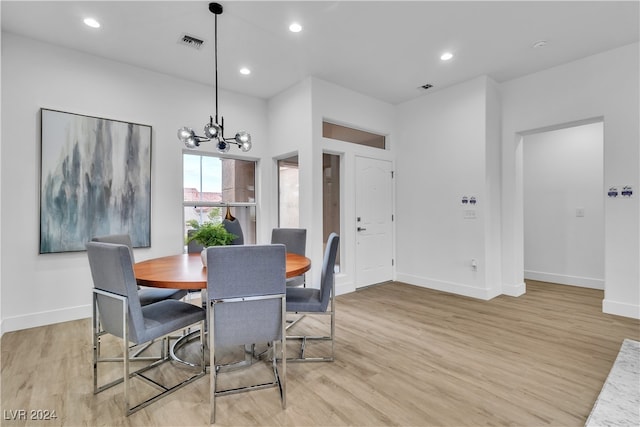 dining space featuring a chandelier and light hardwood / wood-style flooring