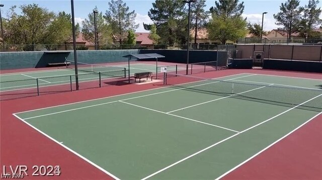 view of tennis court with basketball hoop